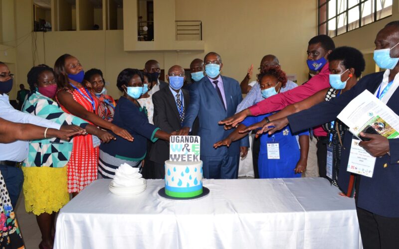Members of the UWEWK National-Organising-Committee-and-participants-cutting-a-cake-during-the-closing-of-the-Uganda-Water-and-Environment-Week-2020